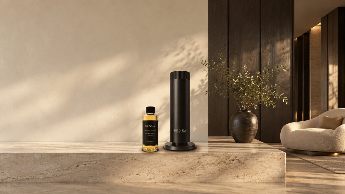 A sunlit marble plinth in a hotel lobby, with the Luma diffuser and an Endless Season oil